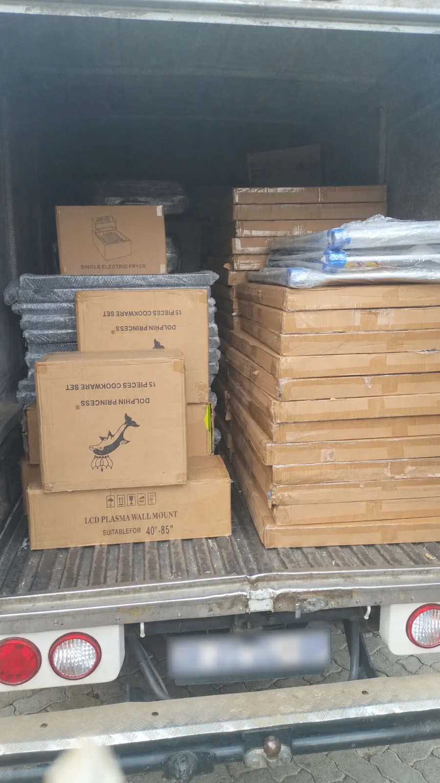 Truck loaded with boxed cookware and wall-mount stock