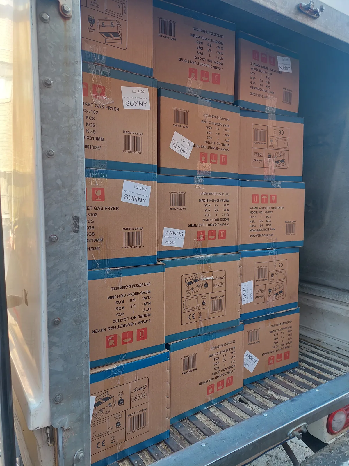 Commercial fryer boxes packed into a delivery vehicle